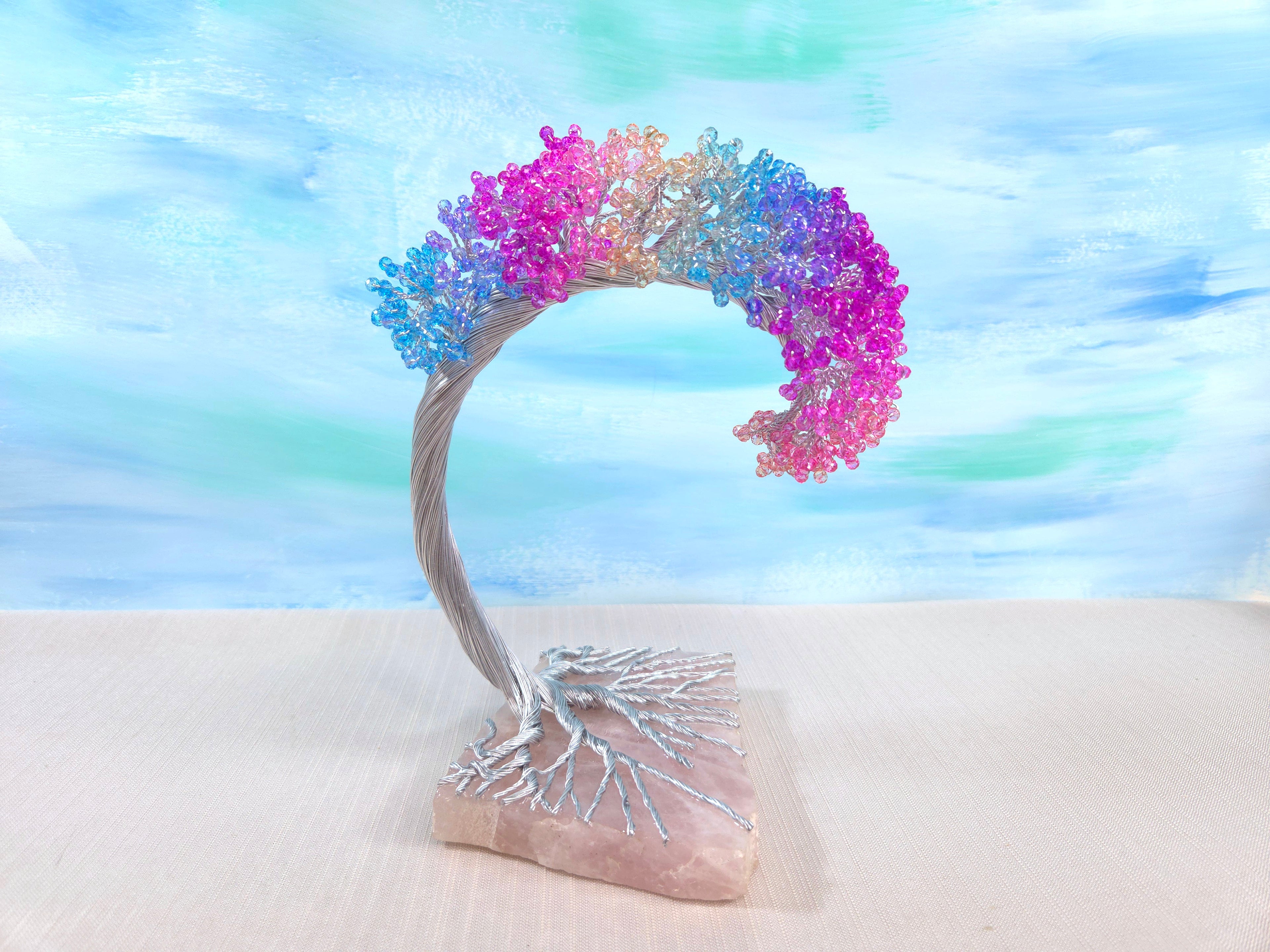 Decorative arch with colorful flowers on a stone base against a blurred natural background