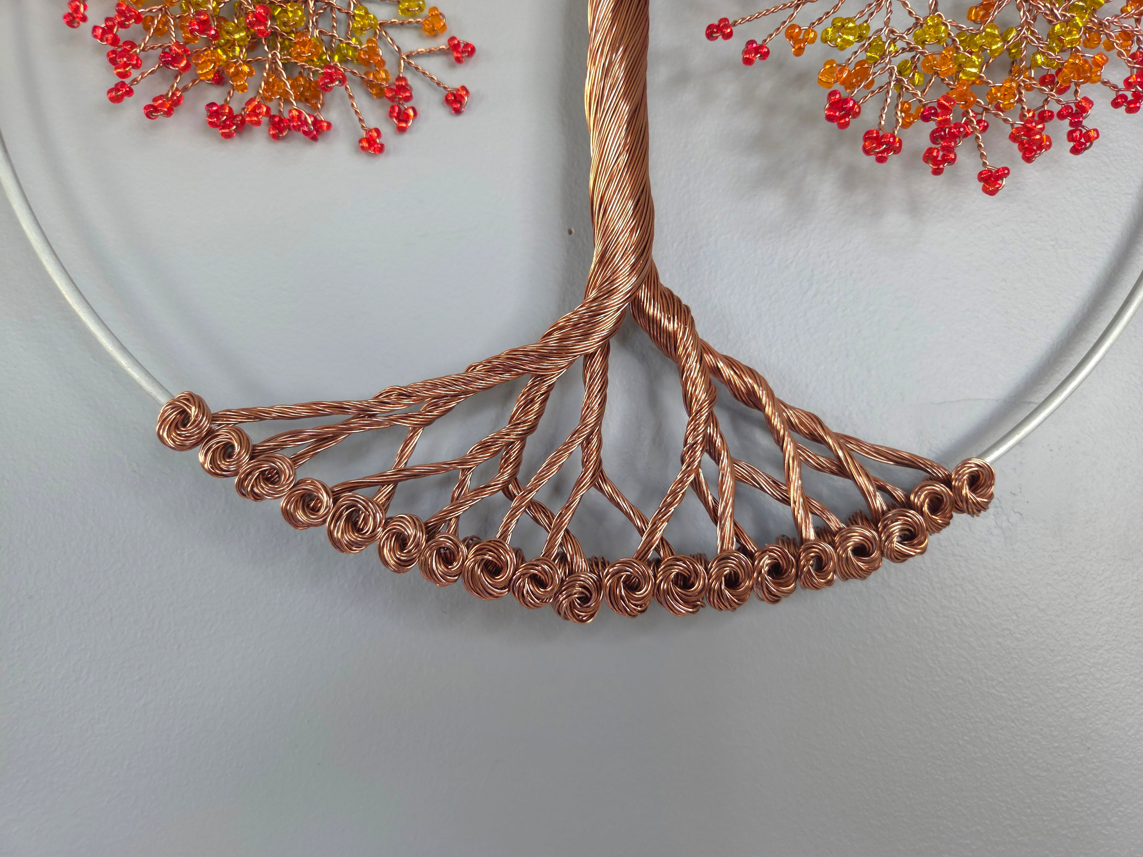 Copper wire tree with red berries on a white background