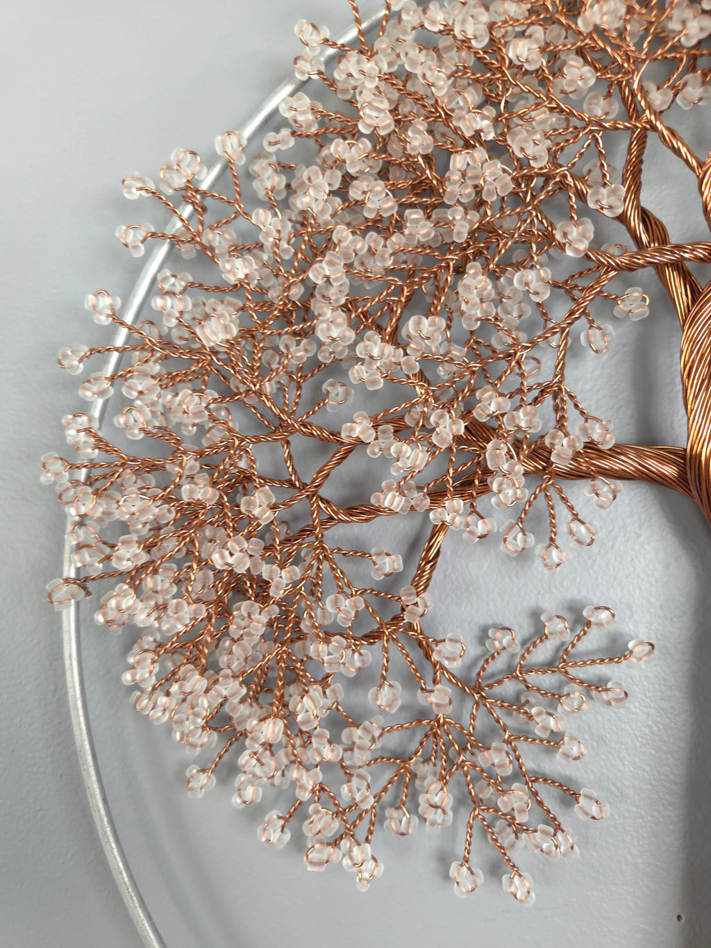Decorative branch with small beads on a light gray background