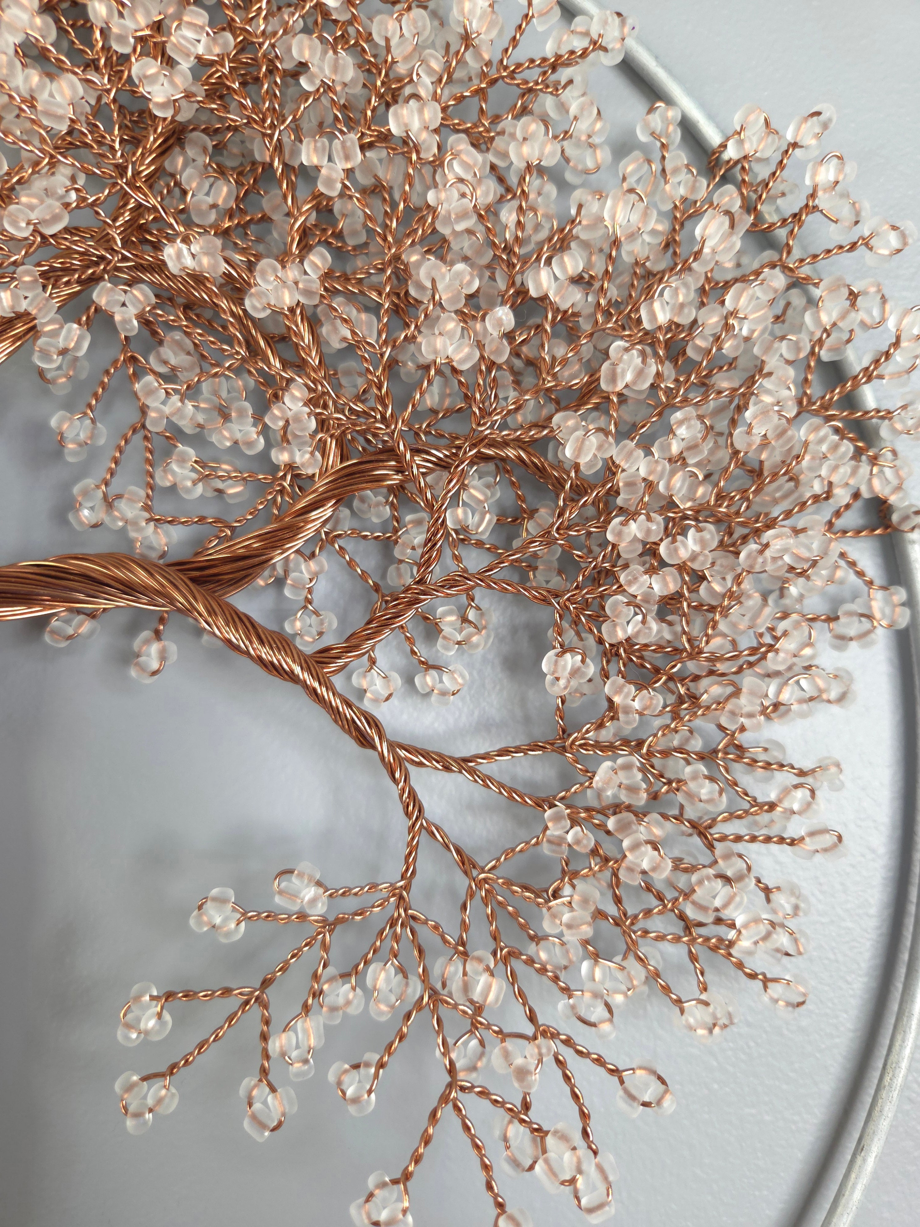 Decorative branch with small crystals on a light gray background