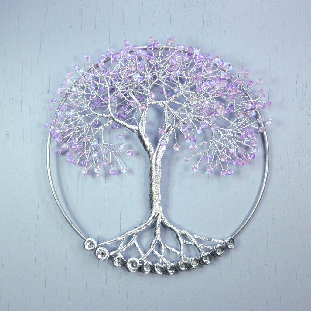 Decorative wall art of a tree with purple branches on a light gray background