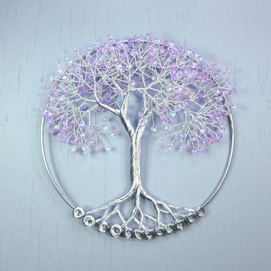 Decorative wall art of a tree with purple branches on a light gray background