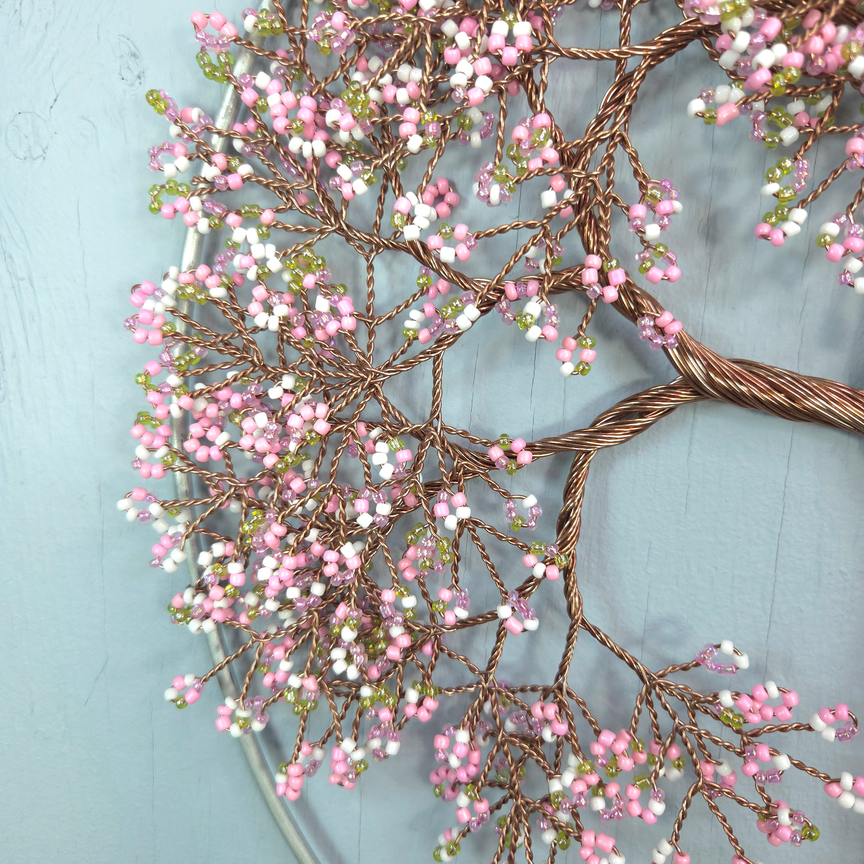 Decorative wreath with pink and white berries on a light blue background