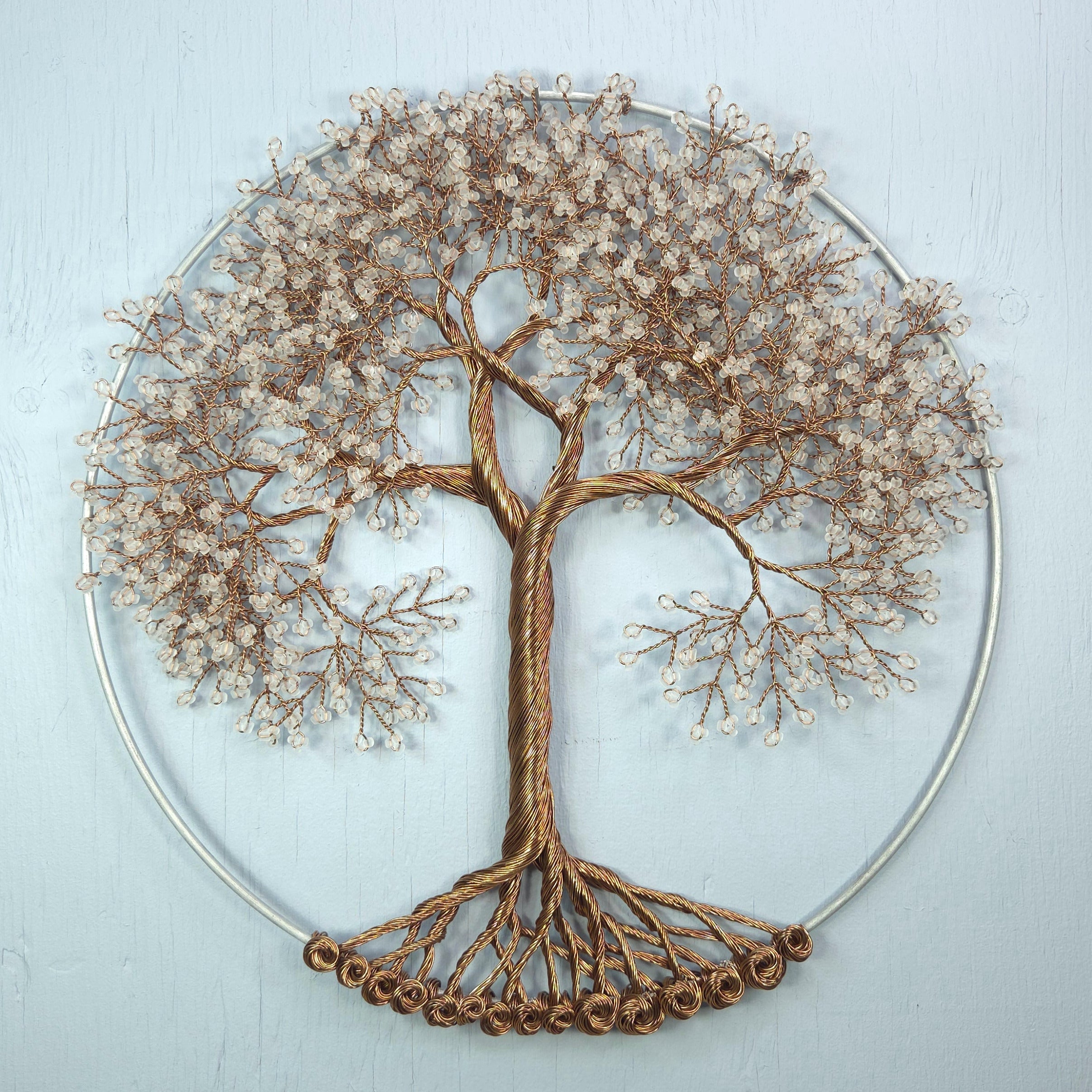 Decorative wall art with a tree design on a light blue background