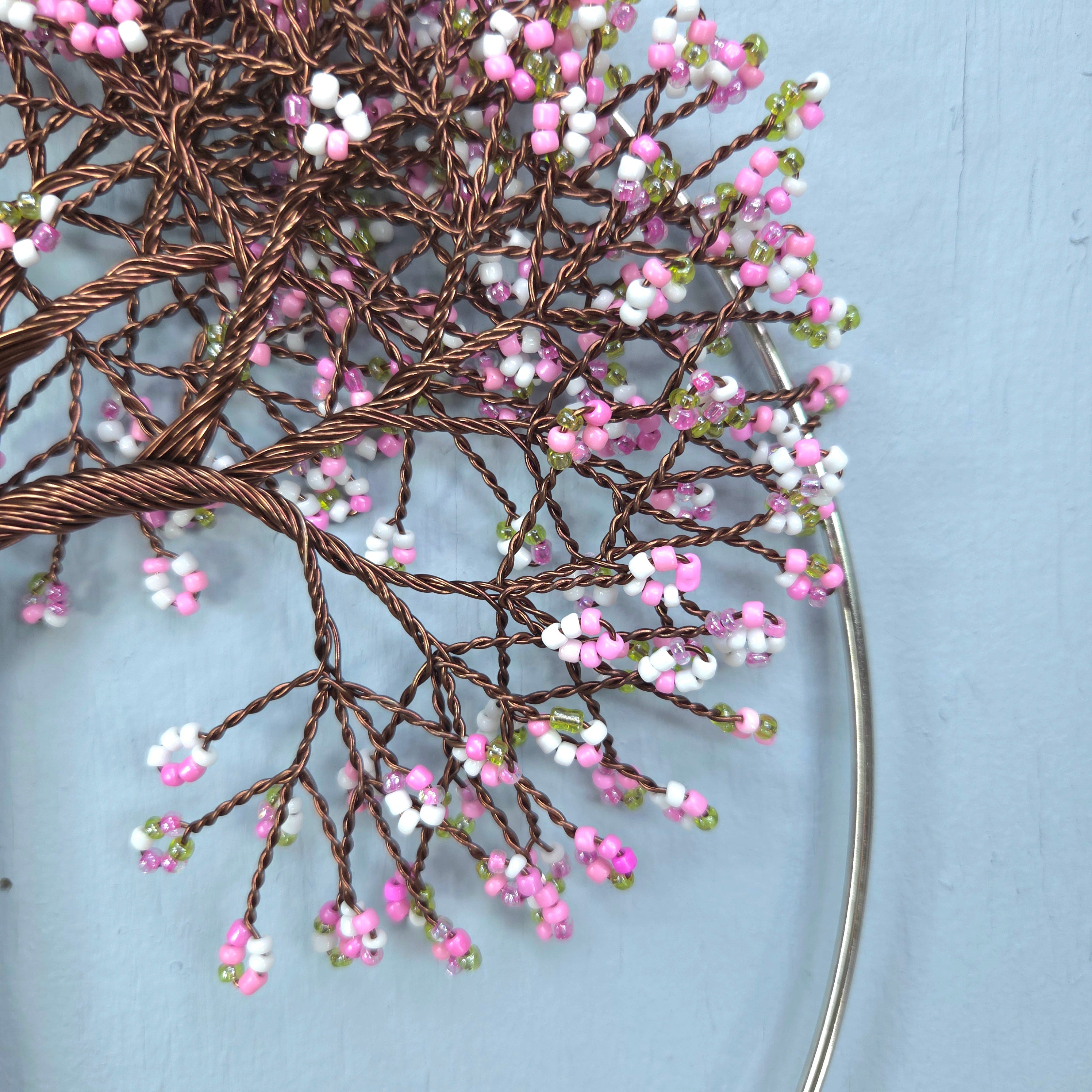 Decorative branch with pink and white flowers on a light blue background
