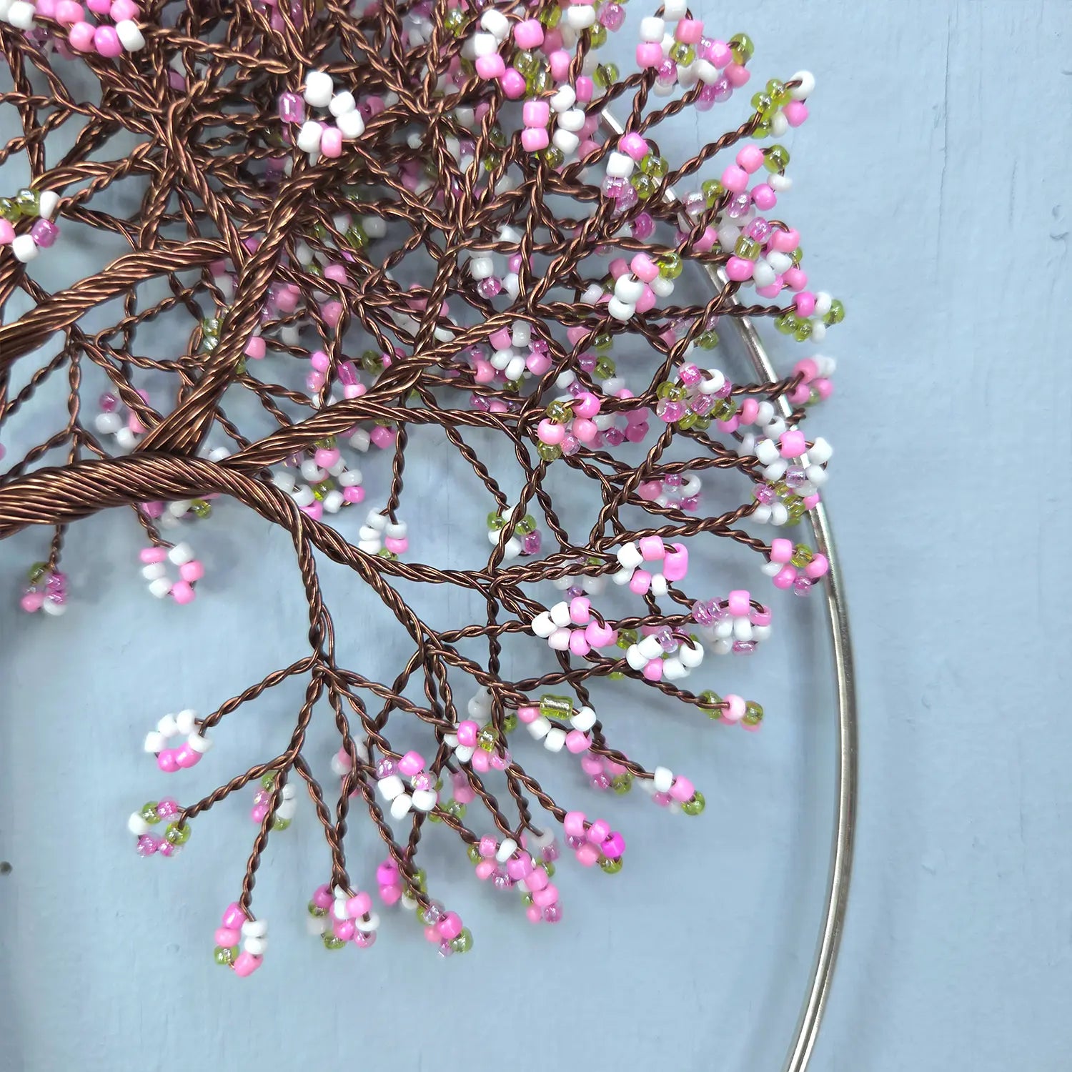 Decorative branch with pink and white flowers on a light blue background