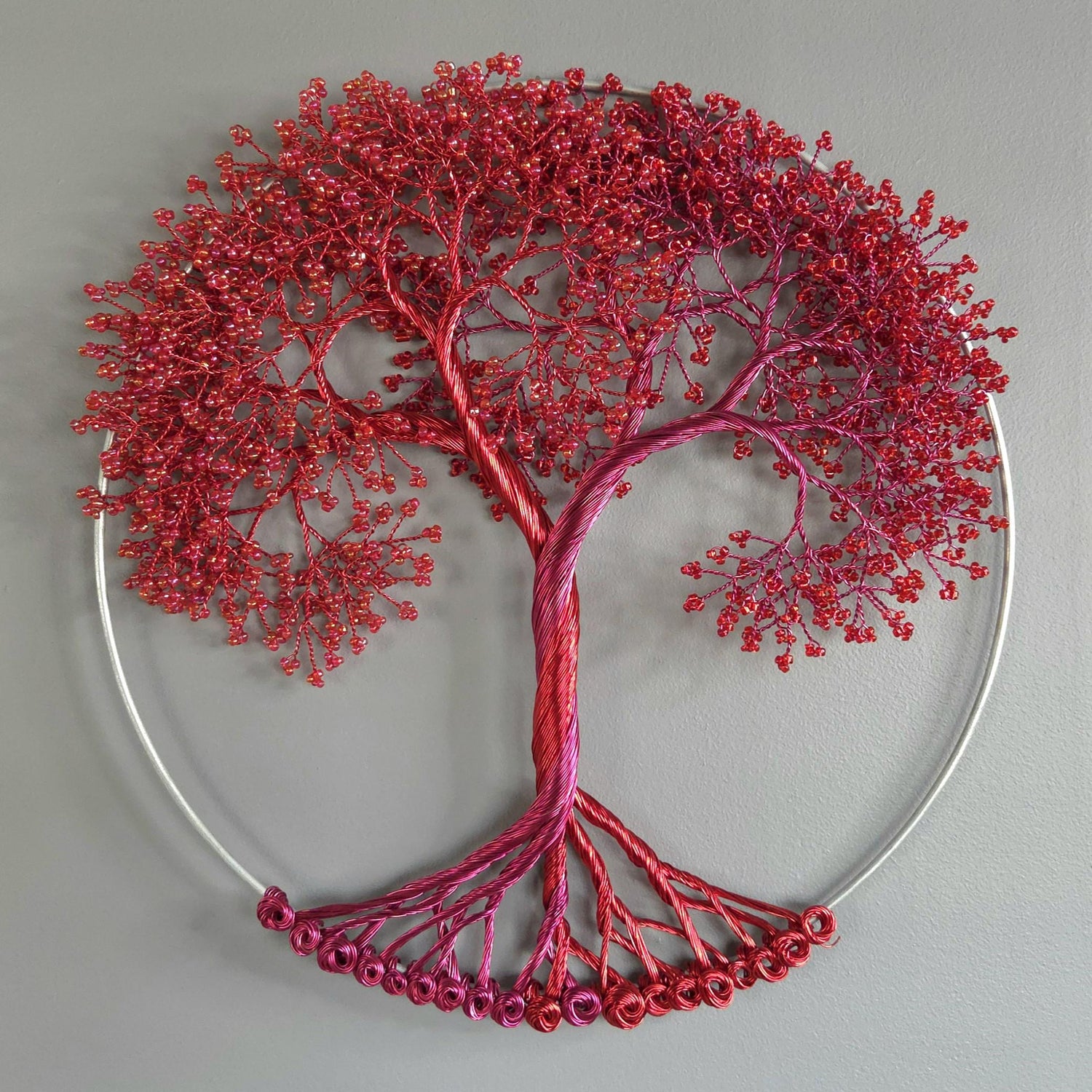 Decorative wall art of a red tree with a gray background