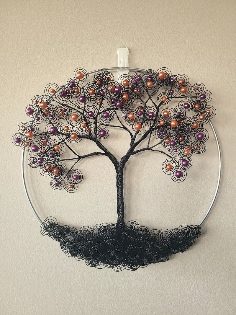 Decorative wall art of a tree with colorful beads on a beige background
