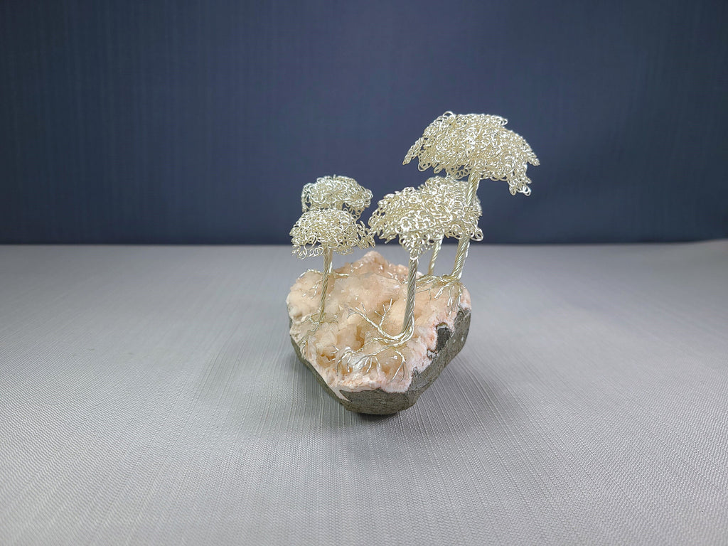 Decorative sculpture of trees on a rock with a dark blue background