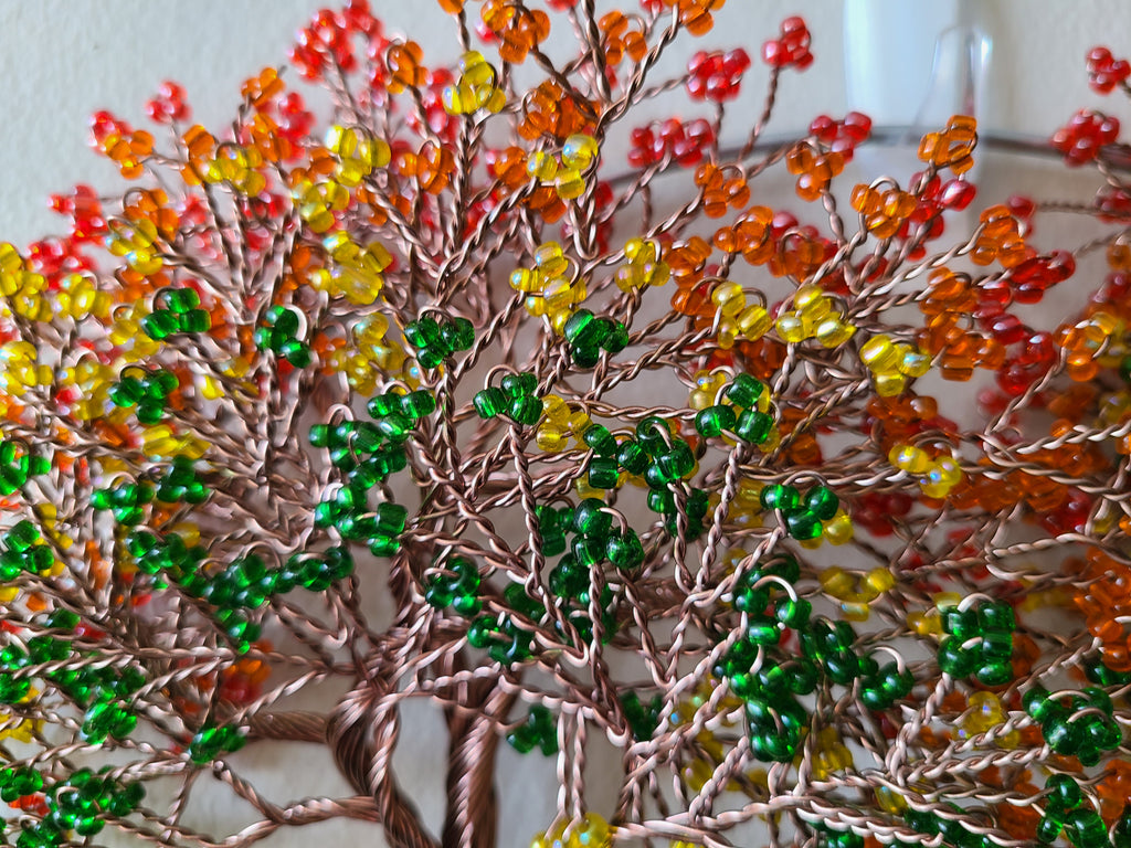 Decorative tree made of beads with autumn colors on a white background