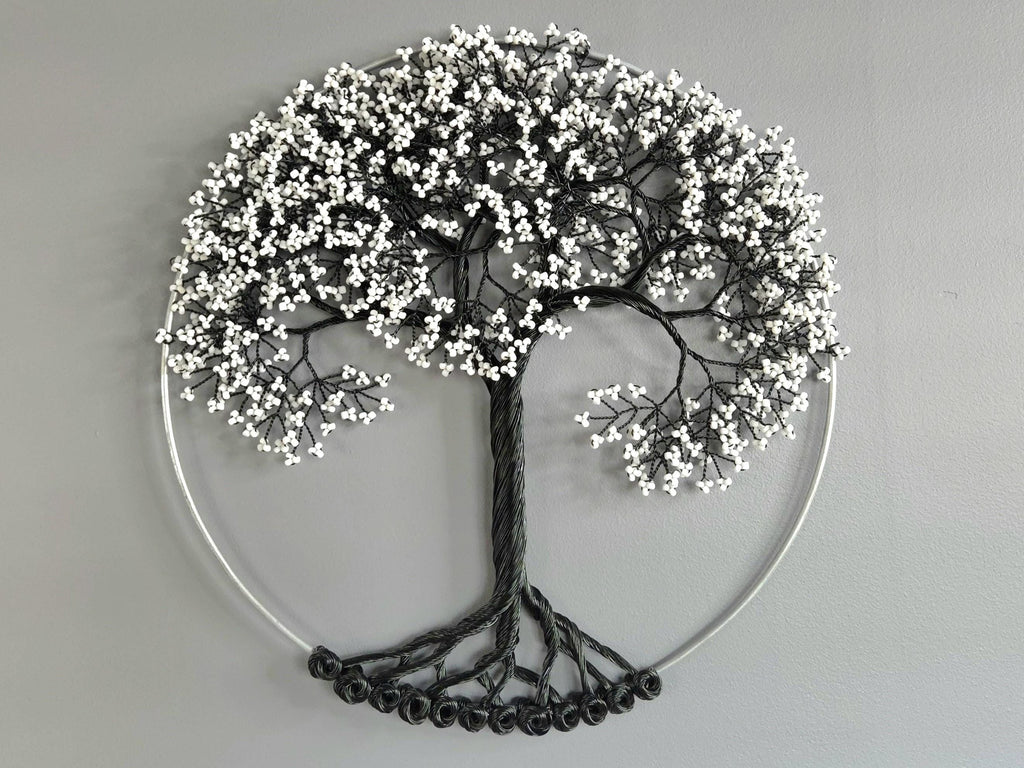 Decorative wall art of a tree with white berries on a gray background