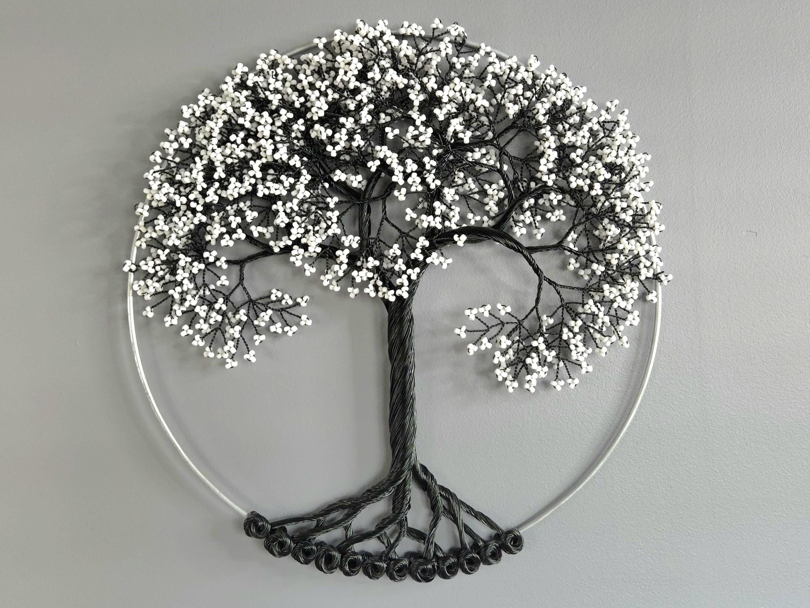 Decorative wall art of a tree with white berries on a gray background