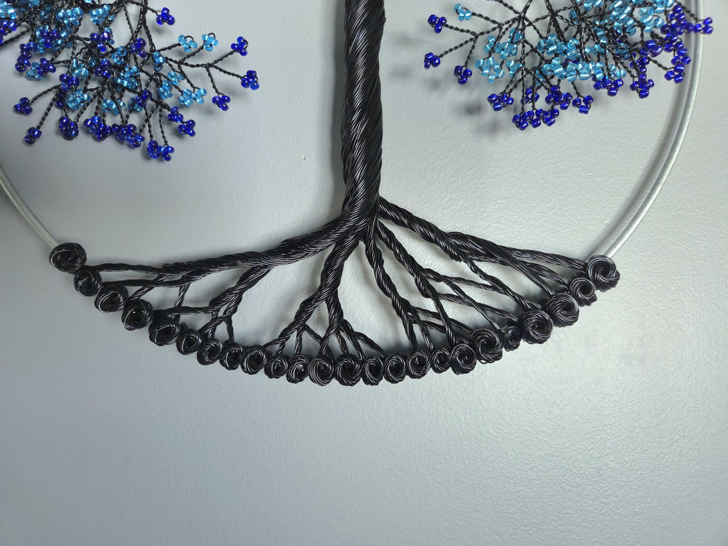 Necklace with black cord and blue bead decorations on a light gray background