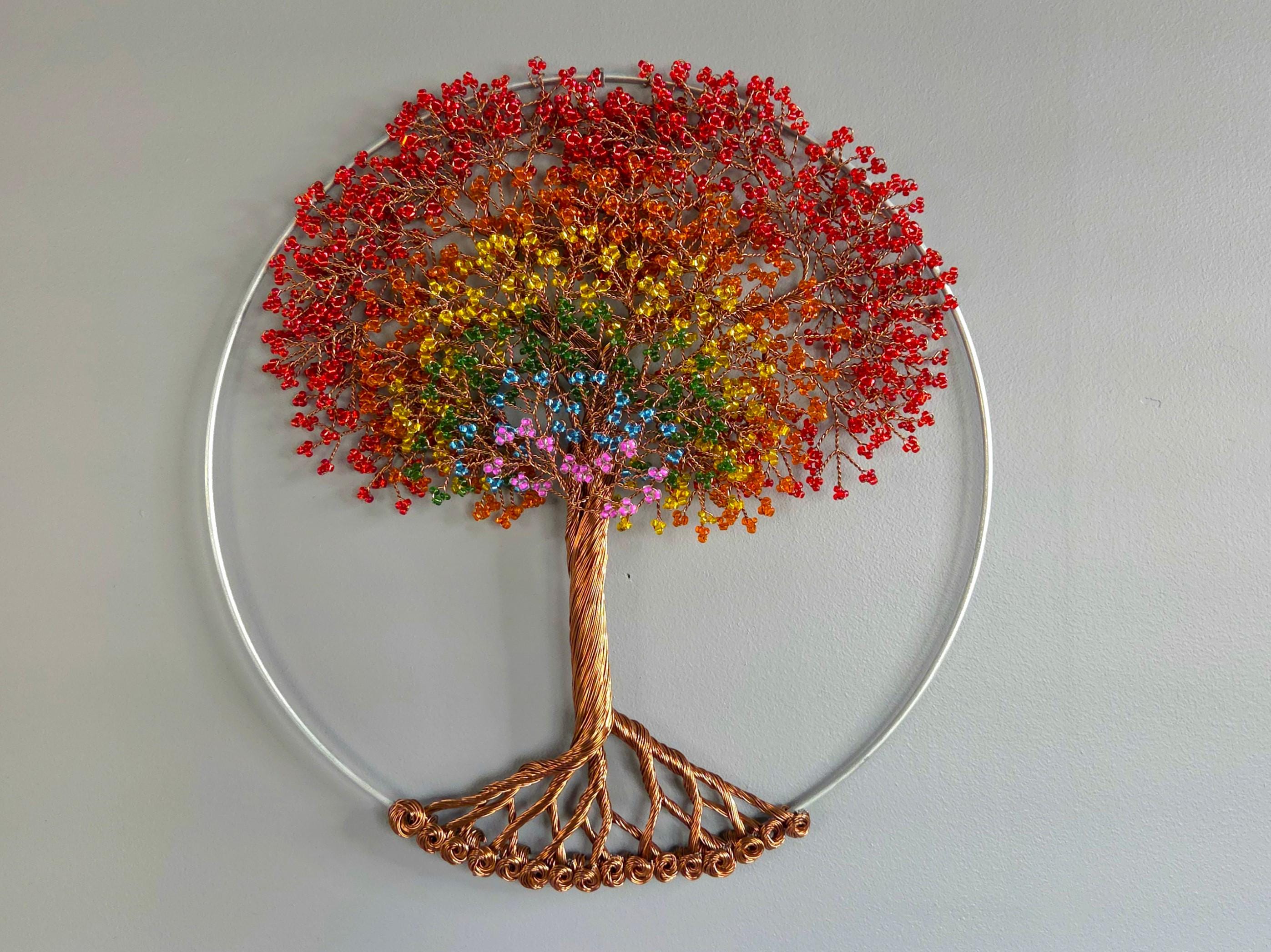 Decorative wall art of a tree with colorful leaves on a plain background