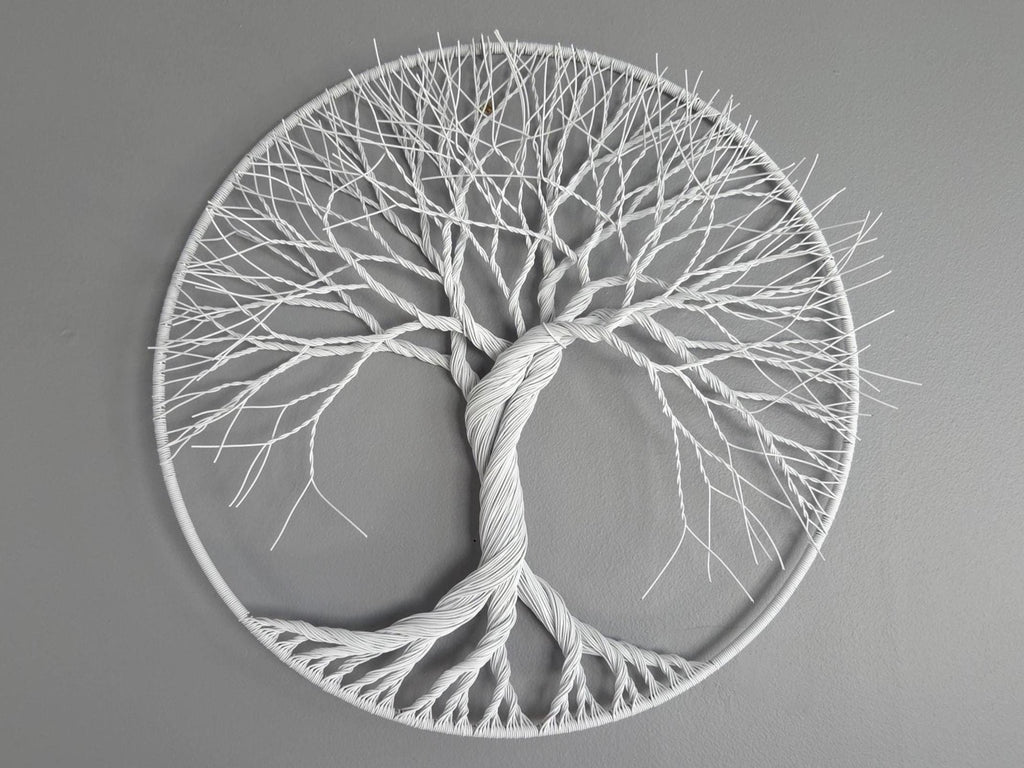 Decorative wall art of a tree with roots and branches on a gray background