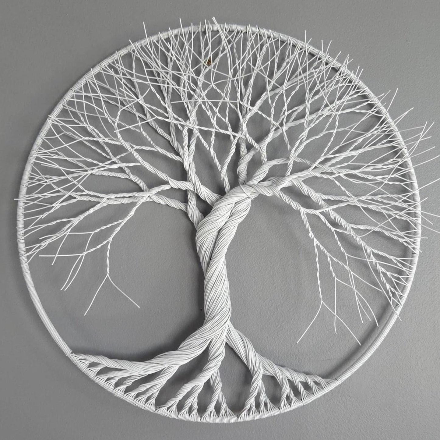 Decorative wall art of a tree with roots and branches on a gray background