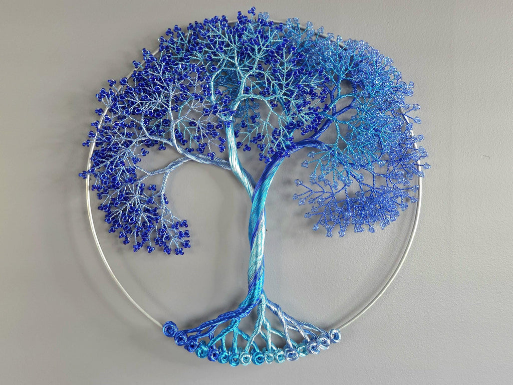 Decorative wall art of a tree with blue branches on a gray background