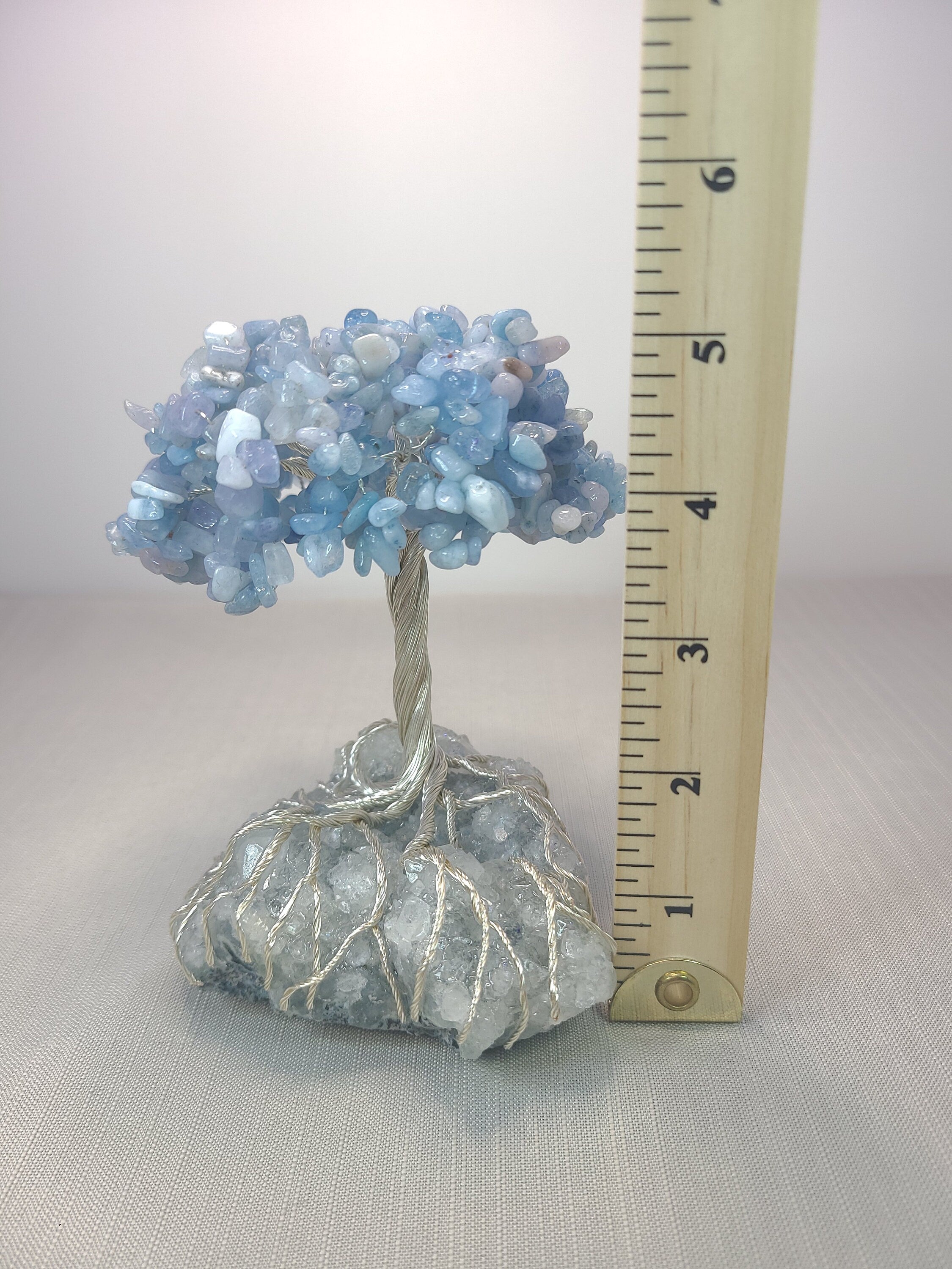 Crystal tree with a ruler for scale on a neutral background