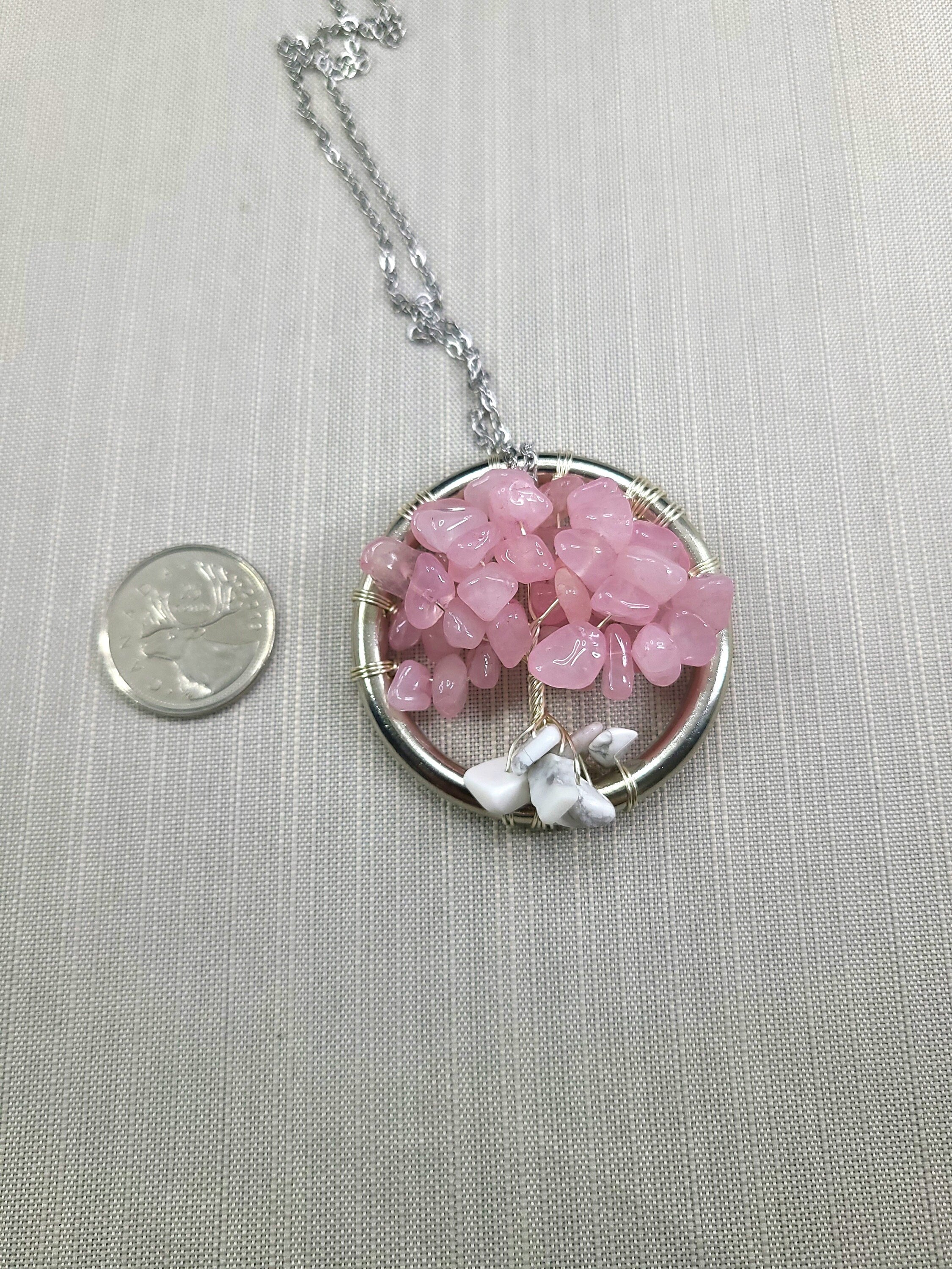 Necklace with pink stone pendant on a light gray background