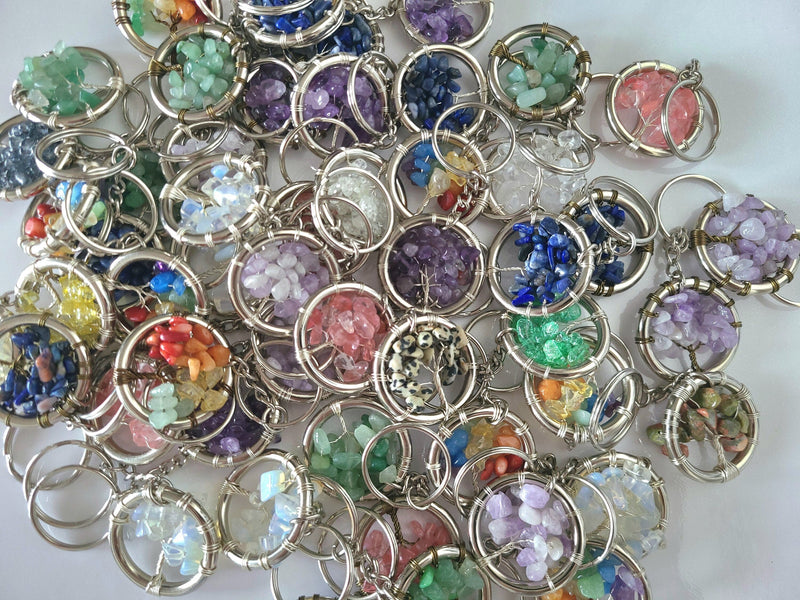 Collection of colorful gemstone keychains on a white background