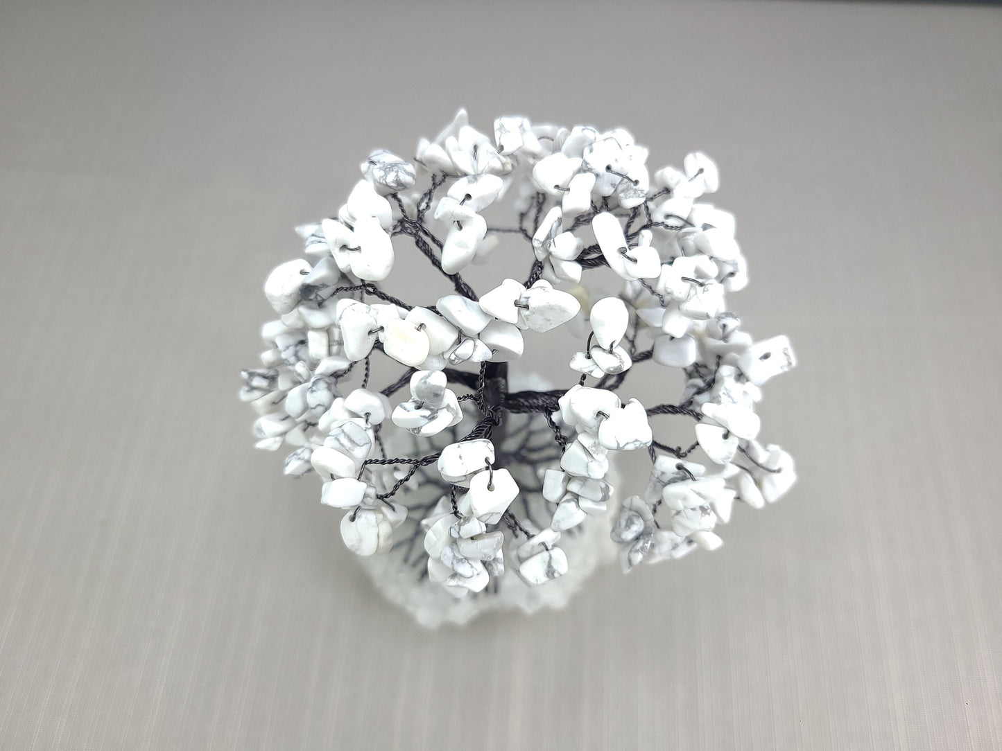 Decorative wreath with white flowers on a gray background