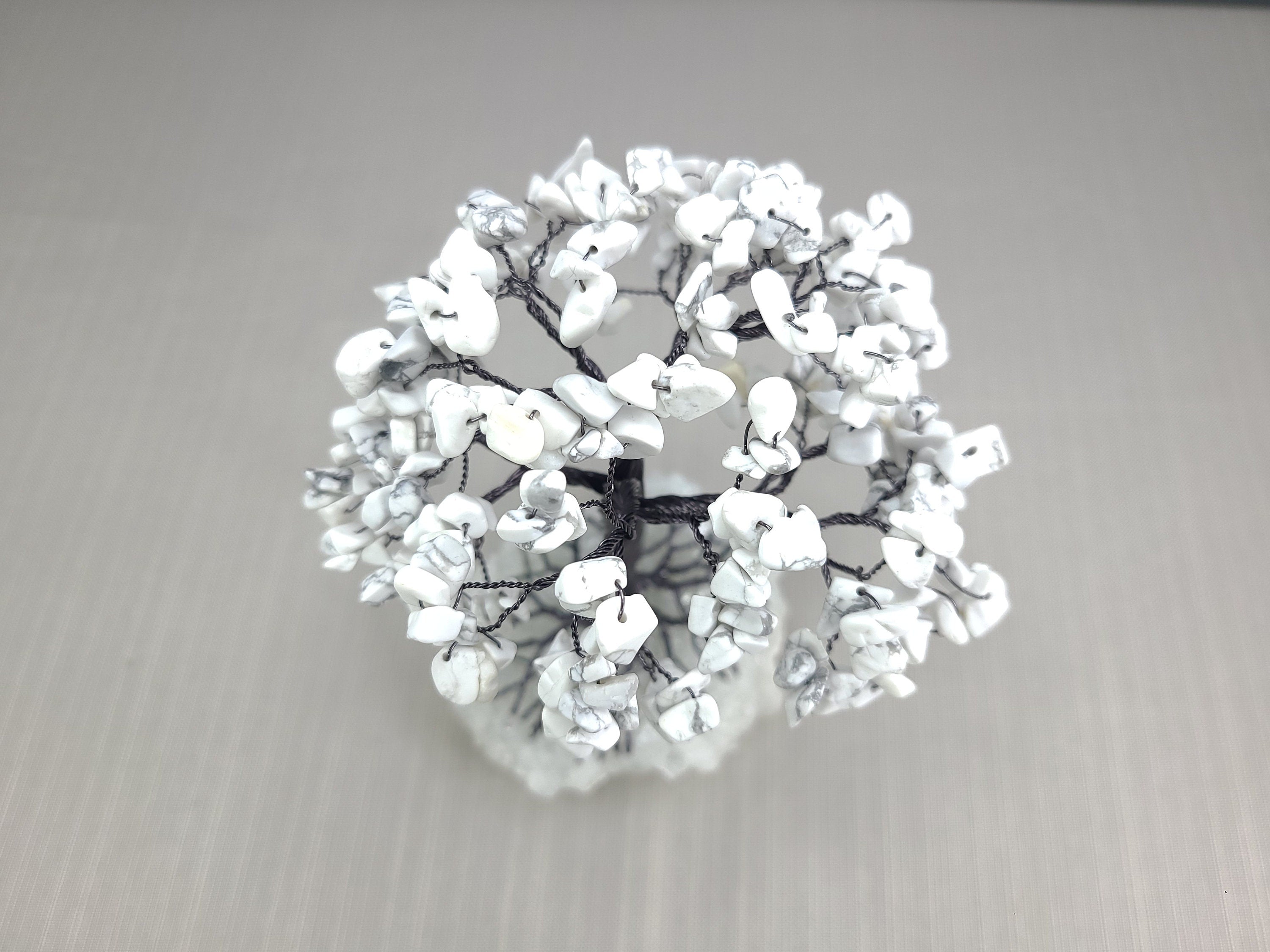 Decorative wreath with white flowers on a gray background