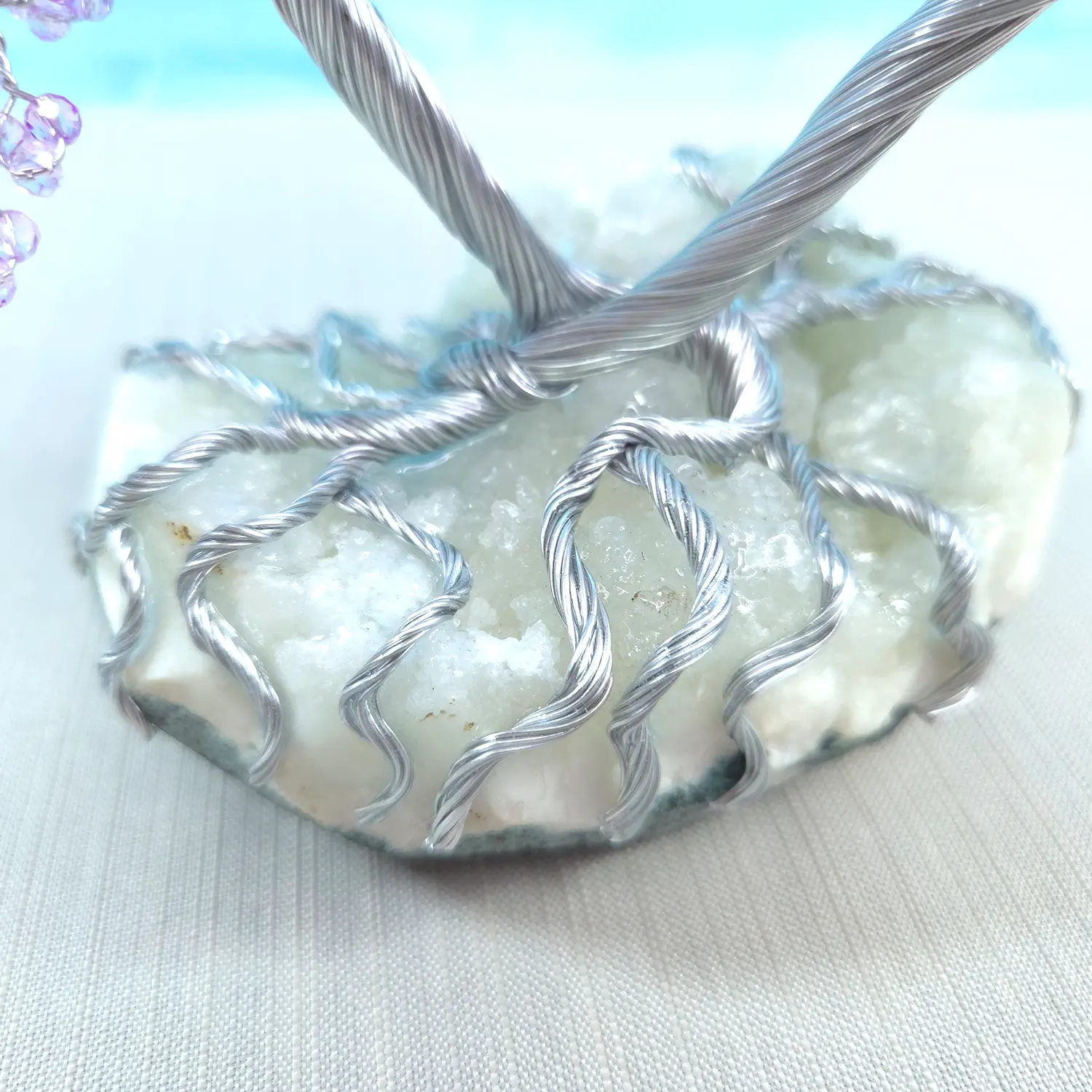 Necklace with a textured stone pendant on a light fabric background