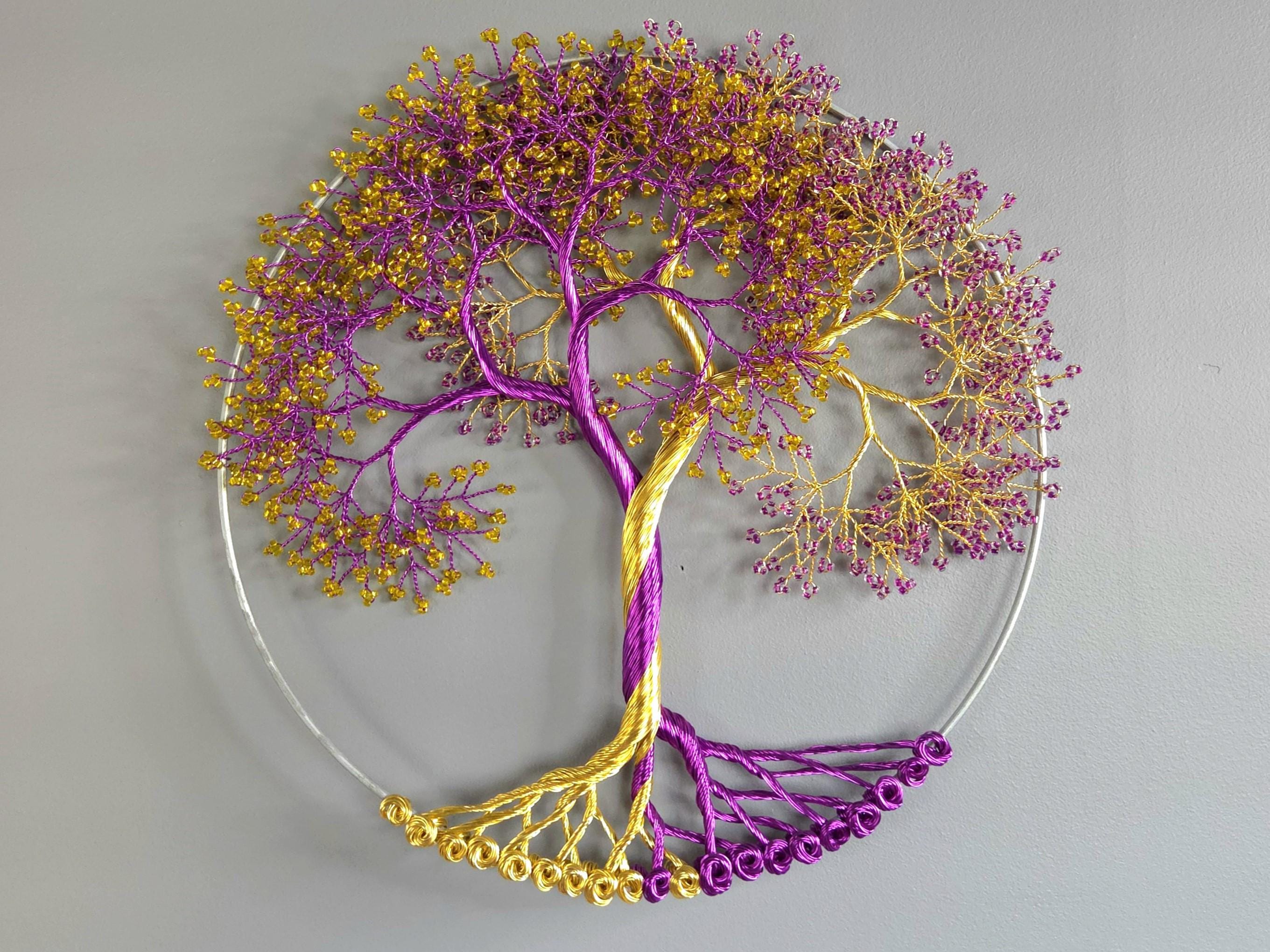 Decorative wall art of a tree with purple and gold branches on a gray background