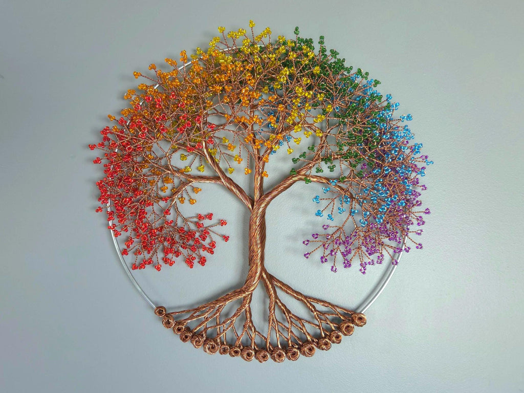 Colorful beaded tree wall art on a light gray background