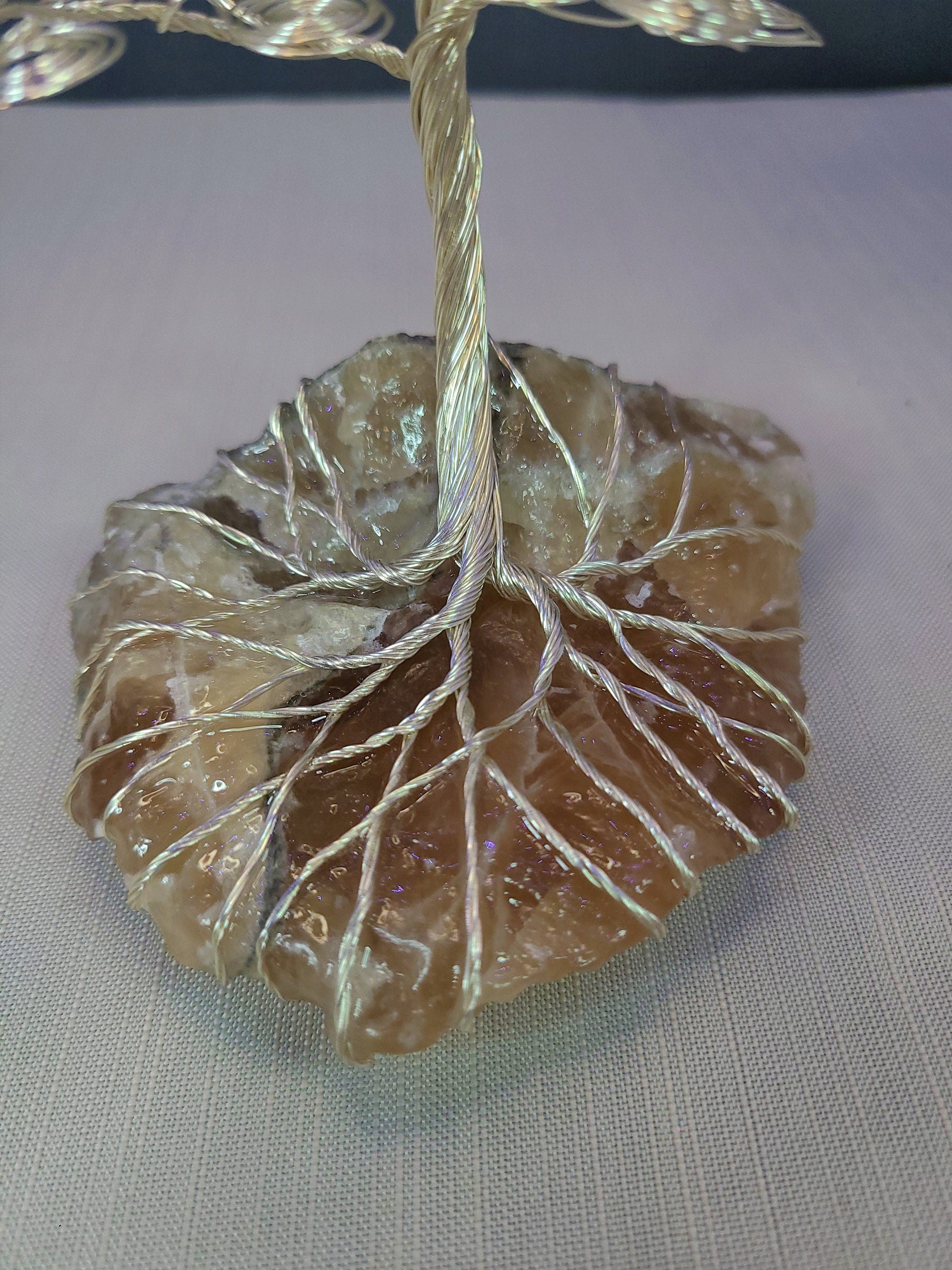 Decorative stone with wire wrapped around it on a light background