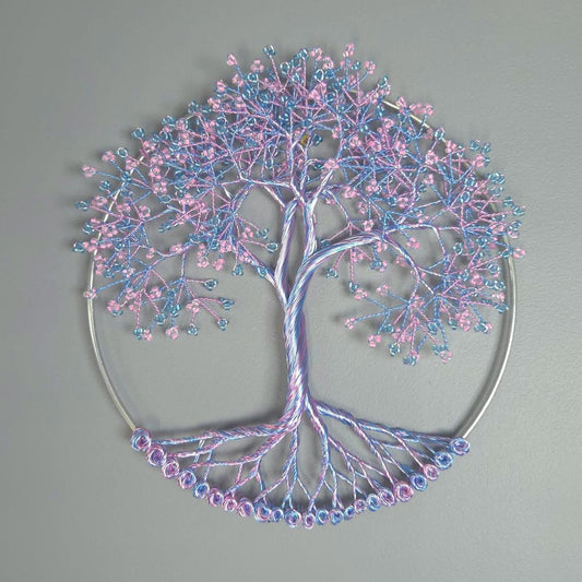 Decorative tree wall art with pink and blue branches on a gray background