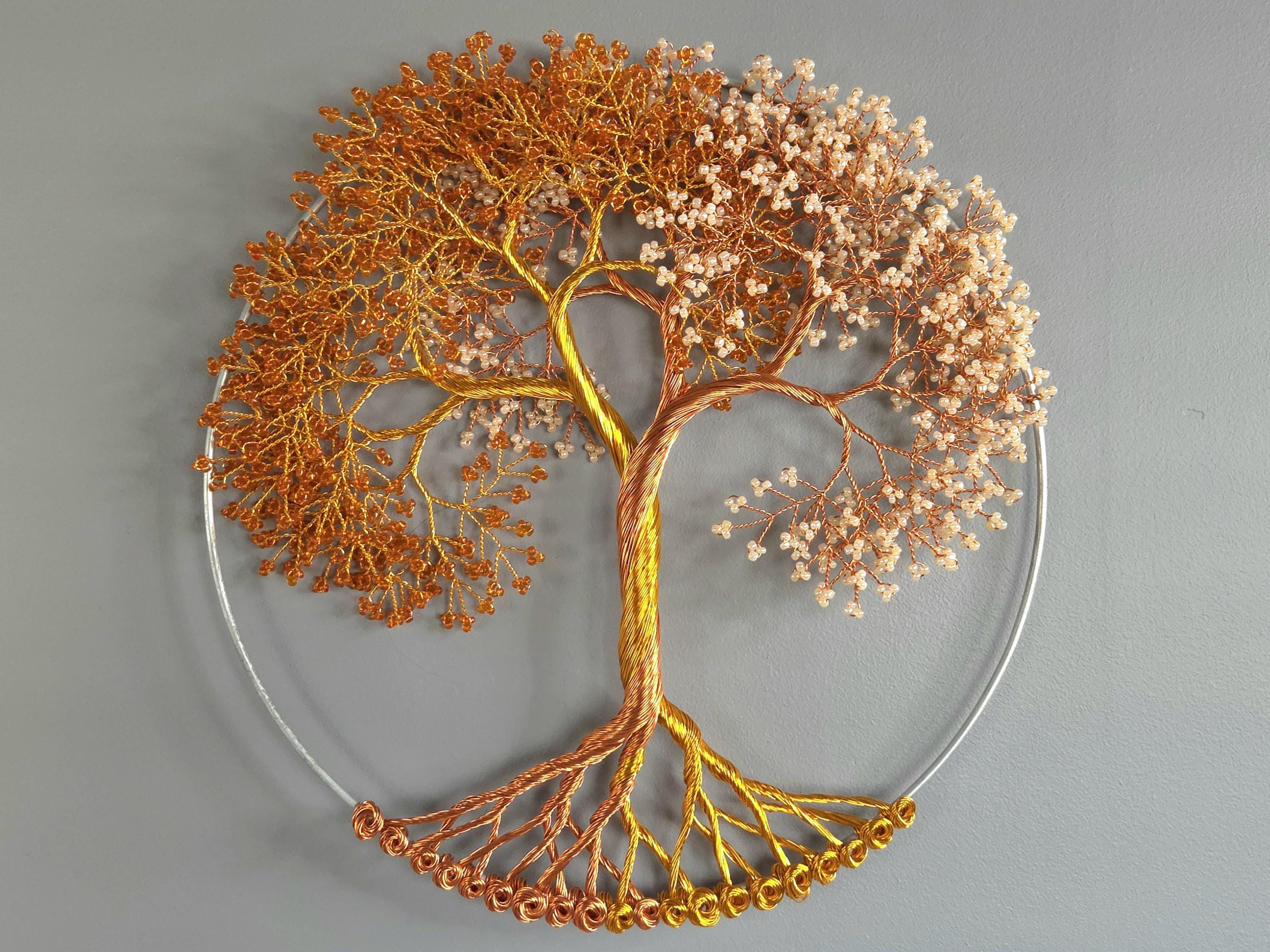Decorative wall art of a tree with branches and leaves on a gray background