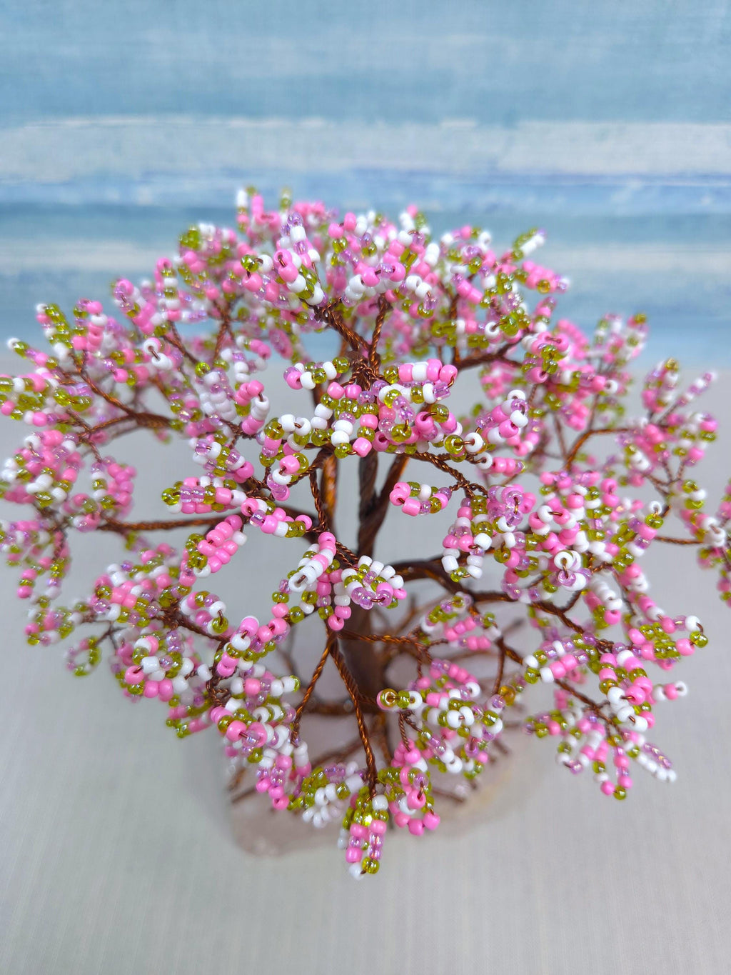 Artificial pink and white floral arrangement on a blurred background