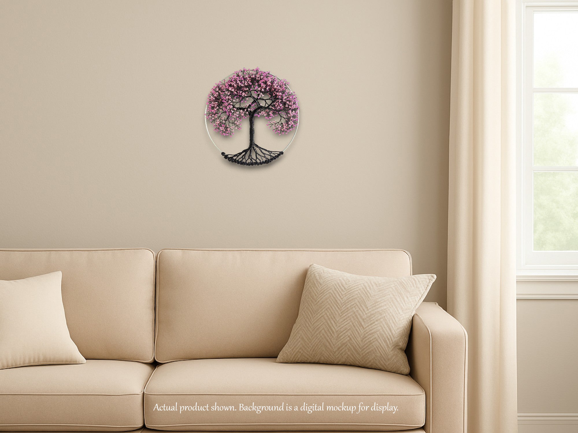 Decorative wall piece with tree of life design on a beige wall above a beige sofa.