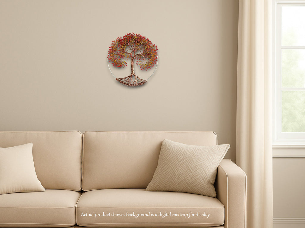 Decorative wall clock with tree design on a beige wall above a beige sofa.