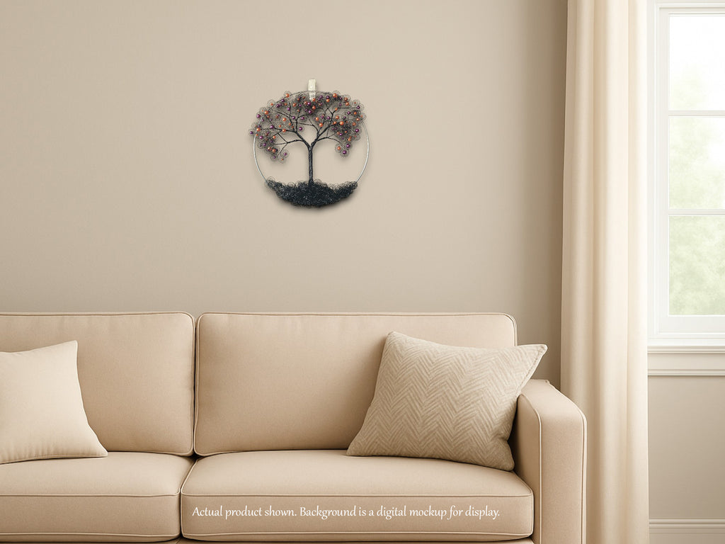 Decorative wall clock with tree design on a beige wall above a beige sofa.