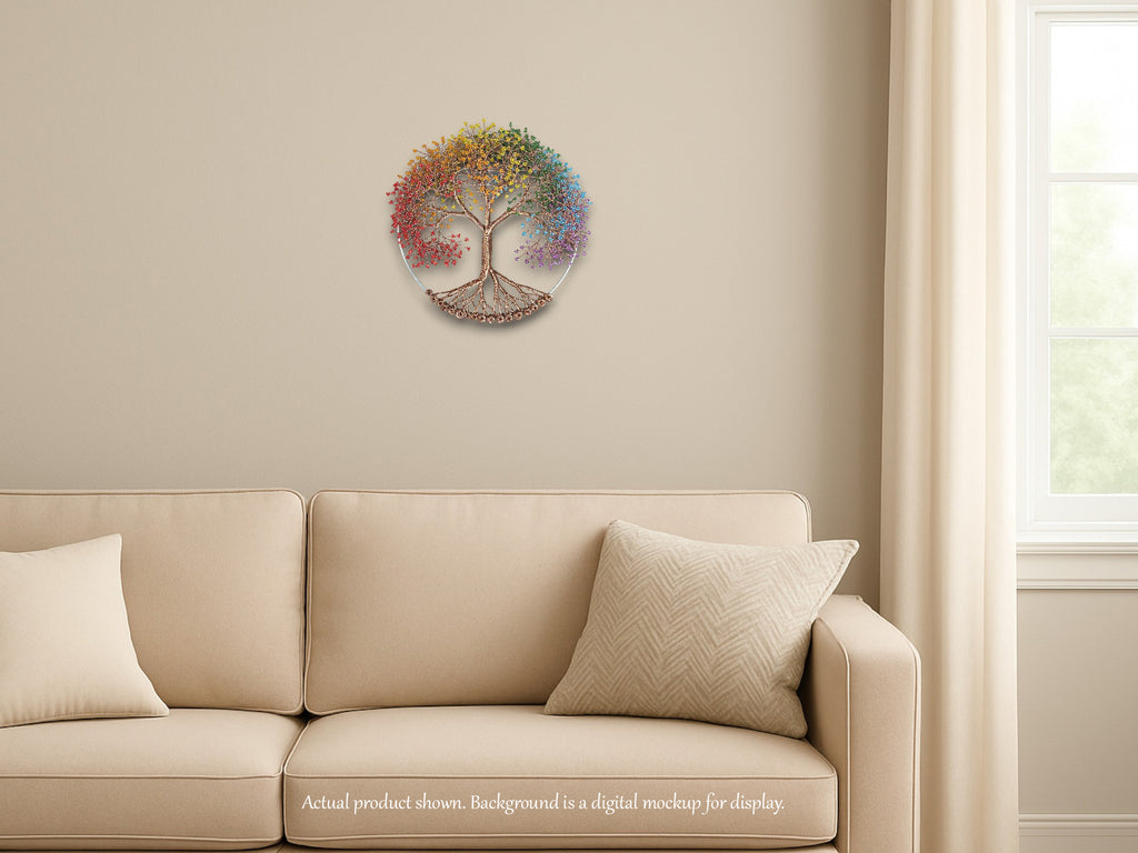 Decorative wall piece resembling a tree with colorful leaves on a beige wall above a beige sofa.