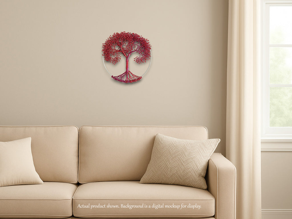 Decorative wall art of a tree with red leaves on a beige wall above a beige sofa.