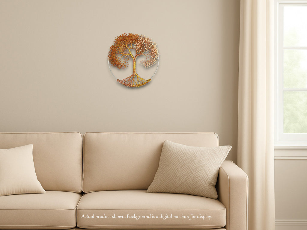 Decorative wall art of a tree with roots and leaves above a beige sofa.