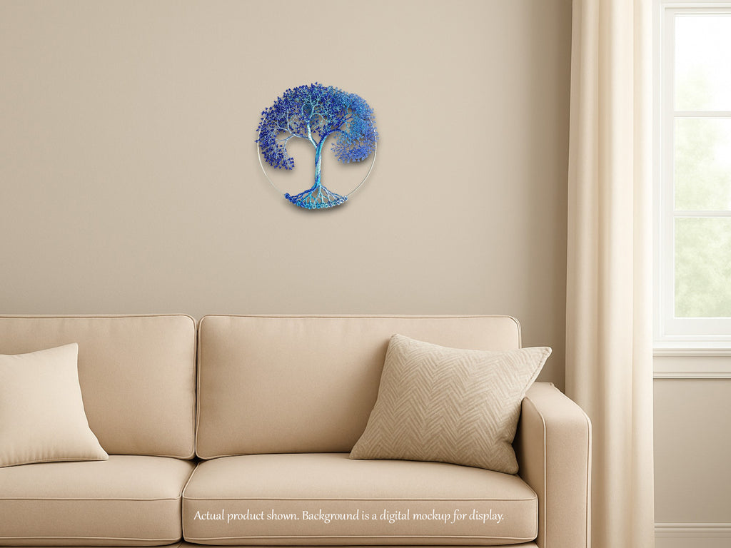 Decorative wall piece of a blue tree on a beige wall above a beige sofa.