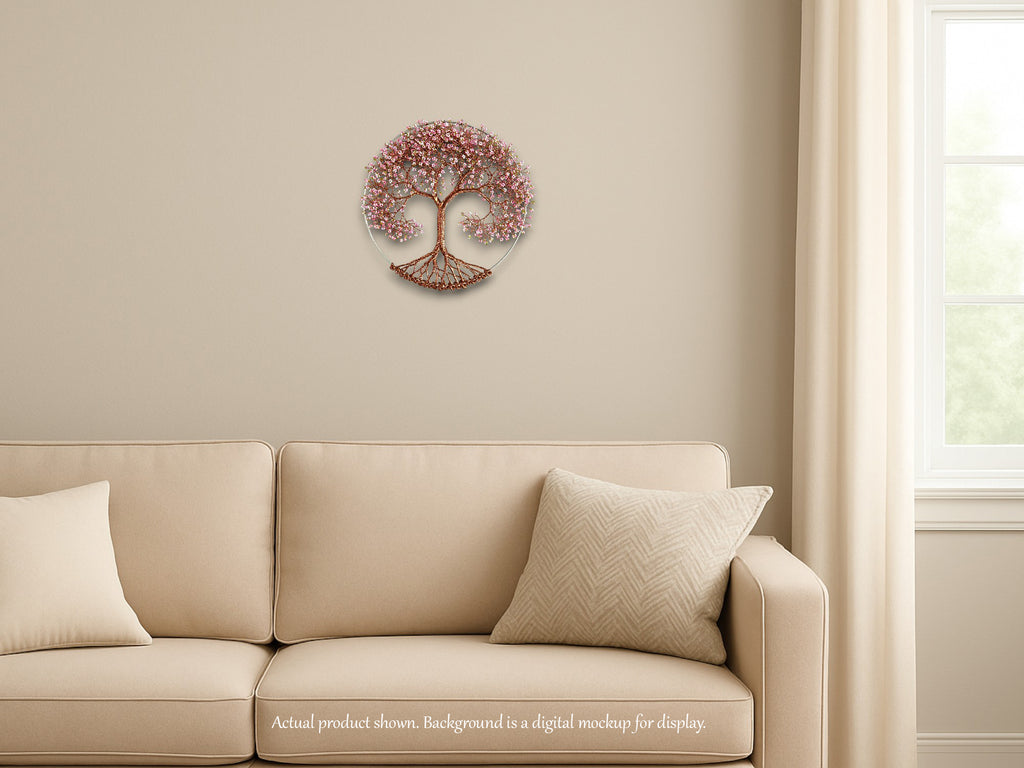 Decorative wall piece resembling a tree of life on a beige wall above a beige sofa.