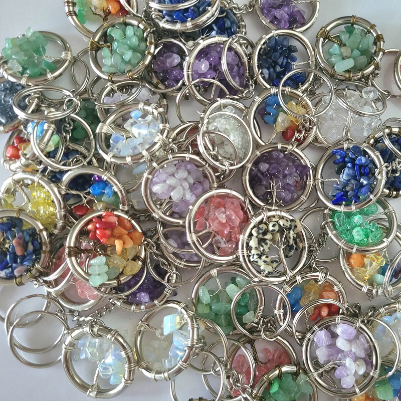 Collection of colorful gemstone keychains on a white background
