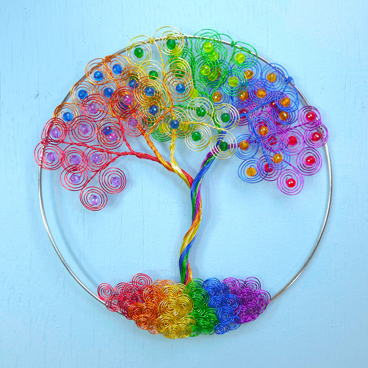 Colorful tree-shaped decorative item on a light blue background