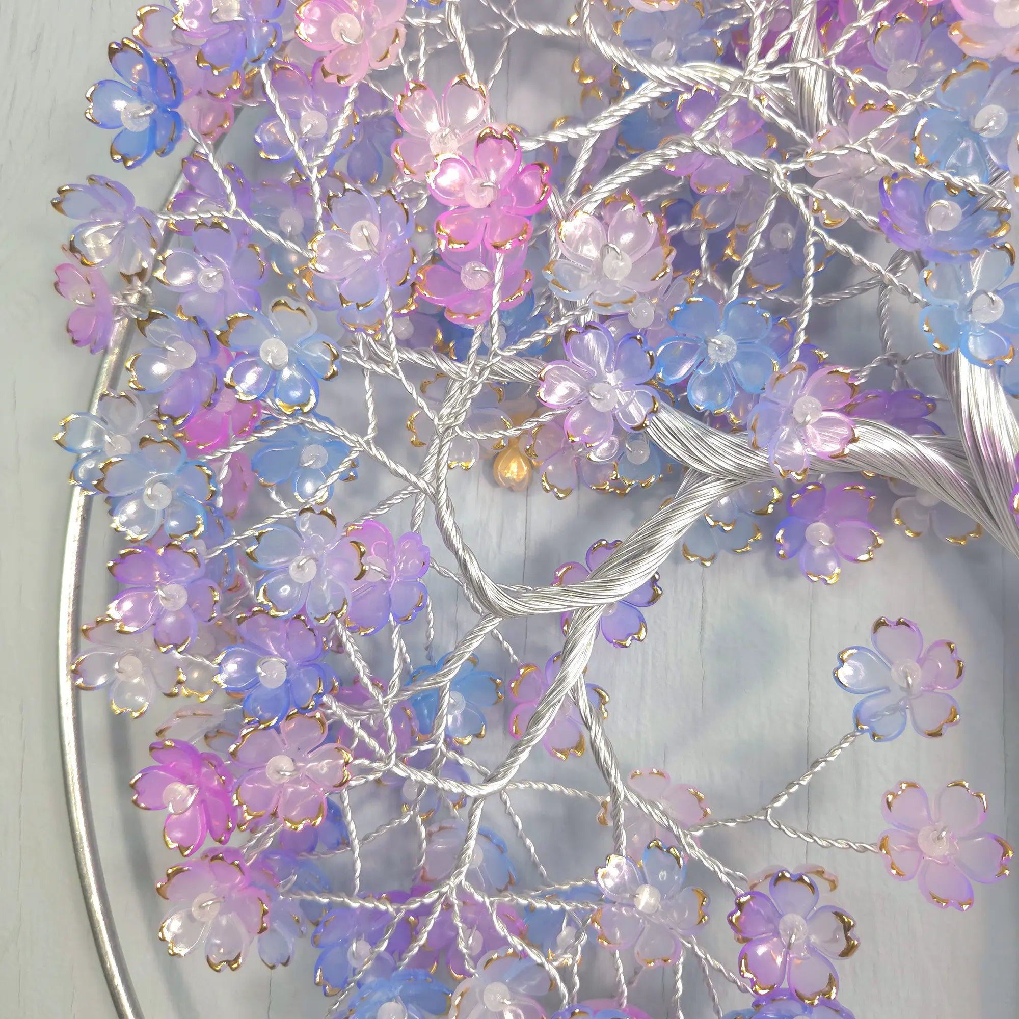 Decorative wreath with purple and pink flowers on a white background
