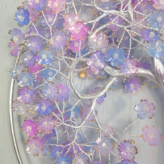Decorative wreath with purple and pink flowers on a white background