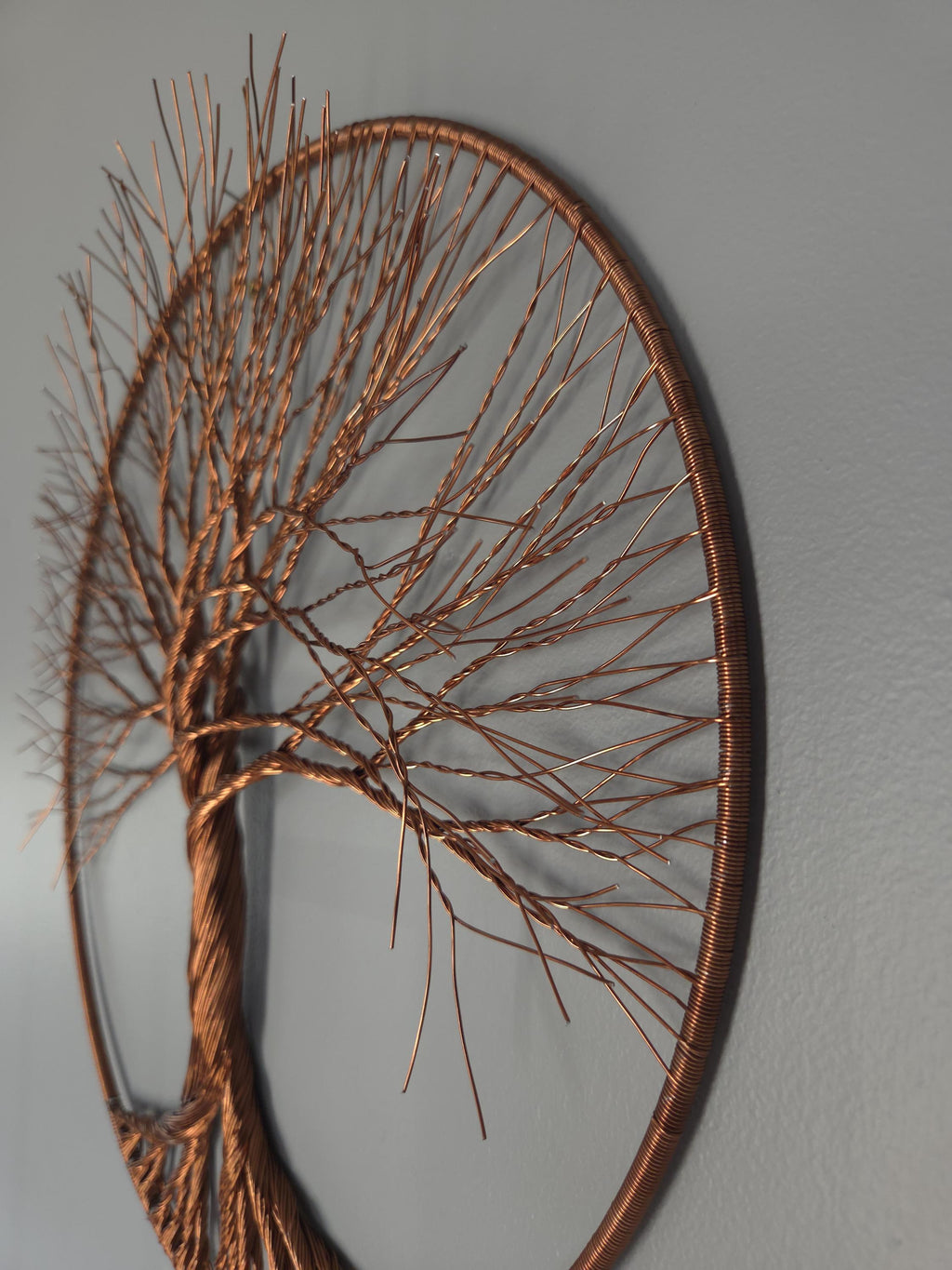 Copper tree wall art on a gray wall