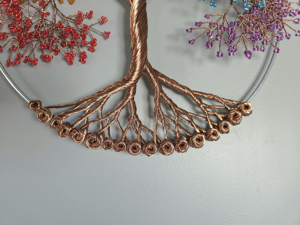 Decorative wreath with copper wire tree design and colorful berries on a light gray background