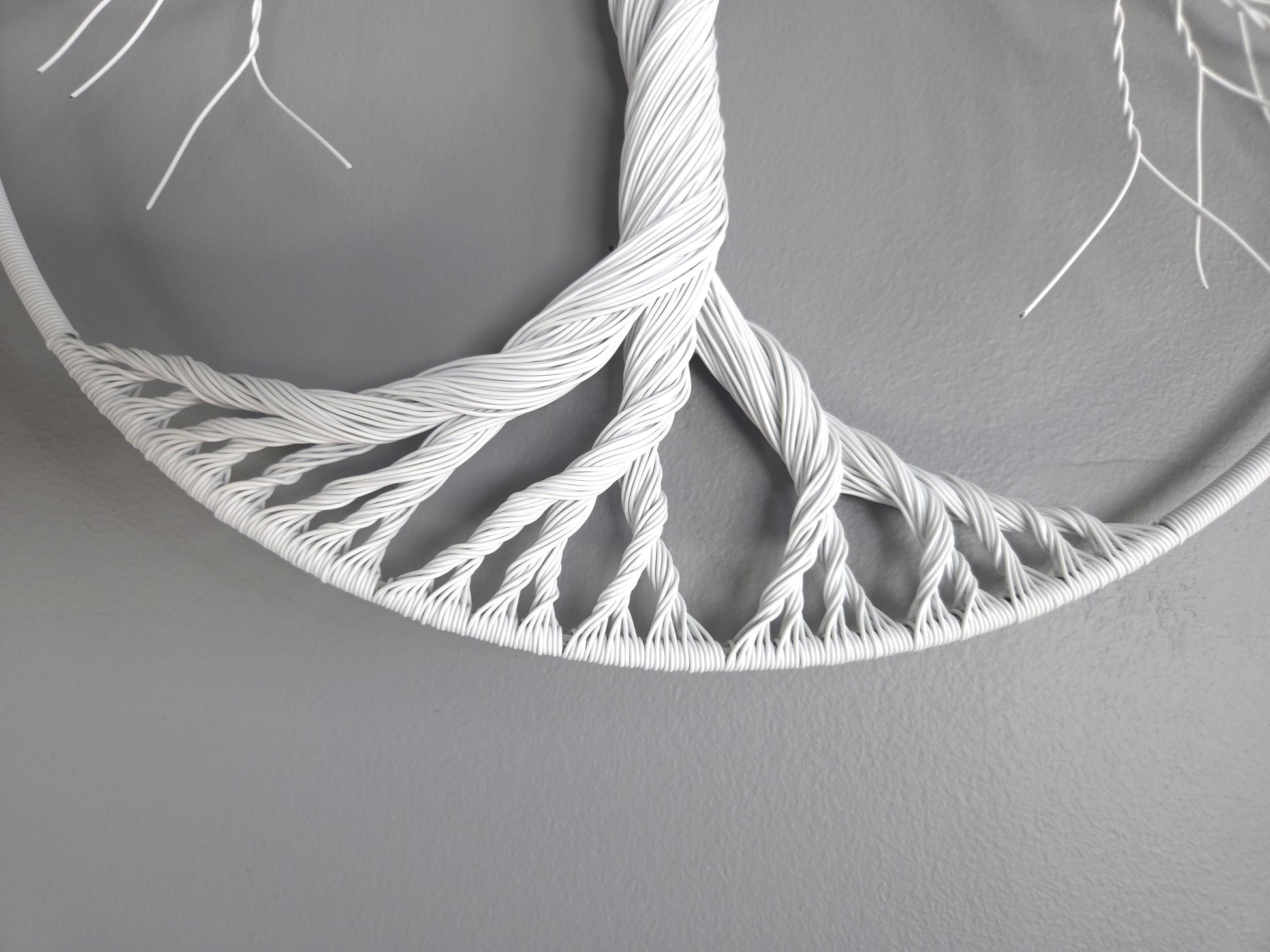 White woven circular object on a gray background