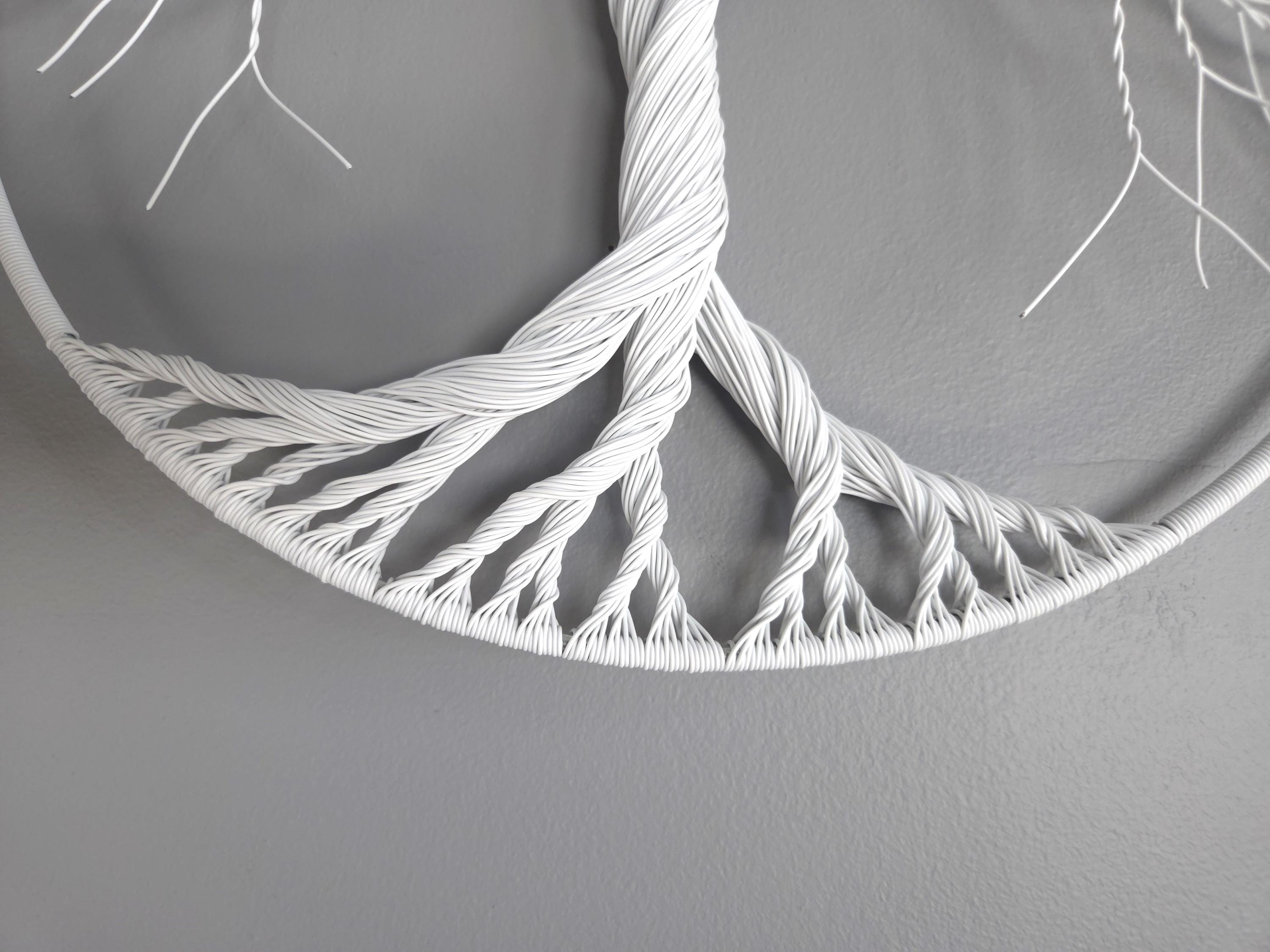 White woven circular object on a gray background