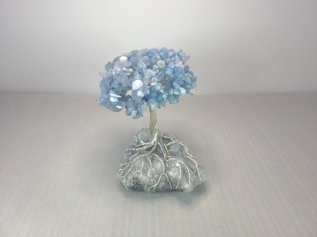 Decorative tree made of blue beads on a gray background